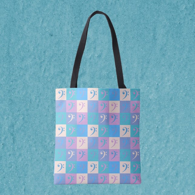Music Bass Clef Pastel Mönster Tygkasse (An all over print tote bag featuring a pattern of bass clefs in yellow, pink, purple and blue.)