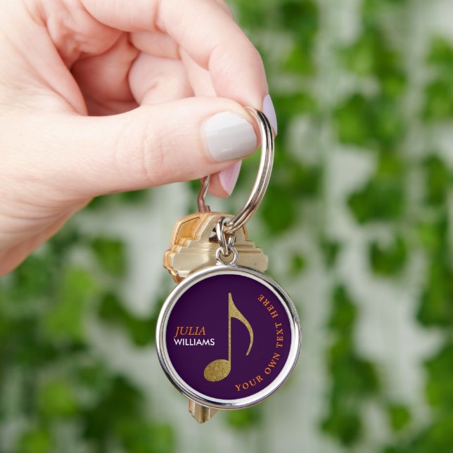 Musikanteckning från guld om nyckelkedjan lila med rund silverfärgad nyckelring (Hand)