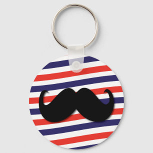 Mustasch med röda, vit- och blåttrandar nyckelring