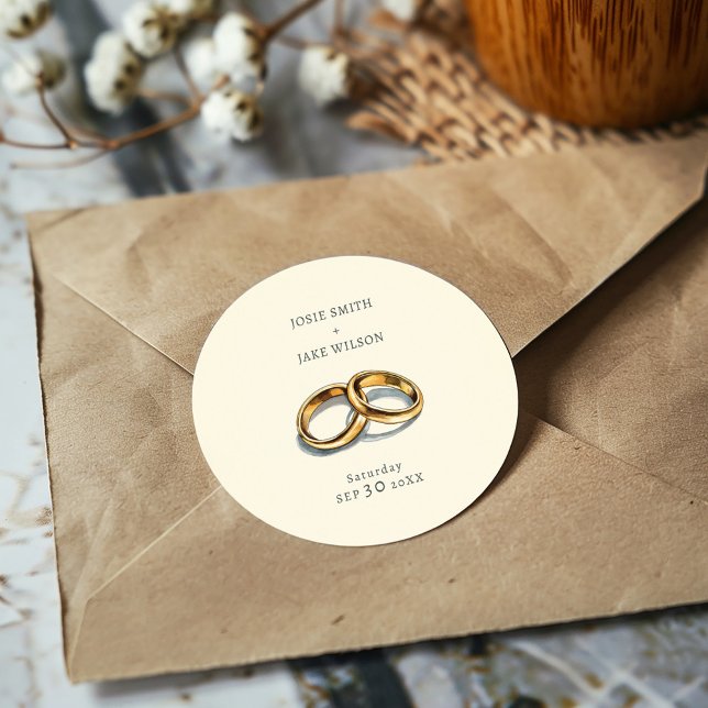 Mute bröllop ringar bröllop runt klistermärke (Delicate gold rings on a muted background sticker, evoking elegance and serene romance for weddings.)