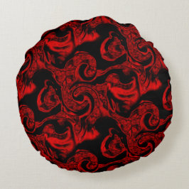 Mycket röda spiral-nedfläckader på svart bakgrund rund kudde