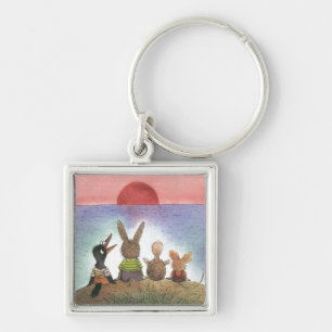 Något som är röd fyrkantig silverfärgad nyckelring