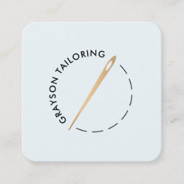 Nål och tråd vid guld fyrkantigt visitkort