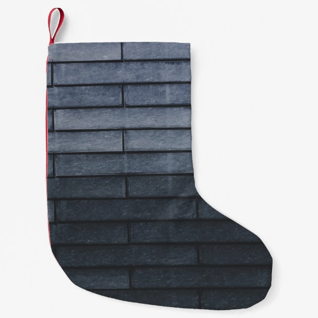 Nära grått-tegelvägg liten julstrumpa (Framsidan)