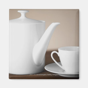 Närbild av en kopp och en saucer med en teakettle magnet