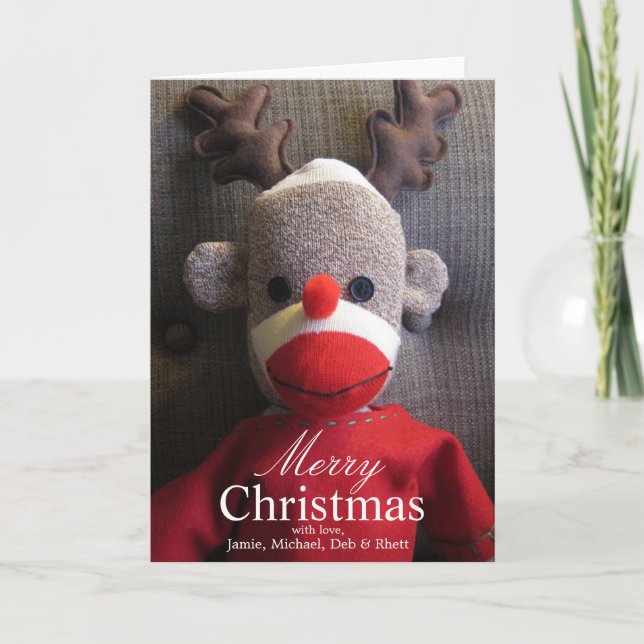 Närbild av sock monkeyansikte med horn på helgkort (Framsida)