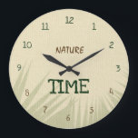 Nature Time Botanical Stor Klocka<br><div class="desc">This elegant Nature Time wall clock features a natural beige background inspired by burlap fabric and warm earthy tones. Soft shadows of tropical leaves create a calm botanical atmosphere, bringing a touch of nature into your space. The dark green and brown typography blends beautifully with the natural color palette, while...</div>