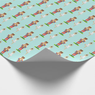 Nötknäppare och balettdansare på ljust teal presentpapper