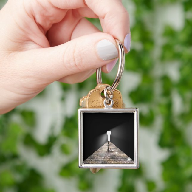 Nyckelhål i rymden fyrkantig silverfärgad nyckelring (Hand)