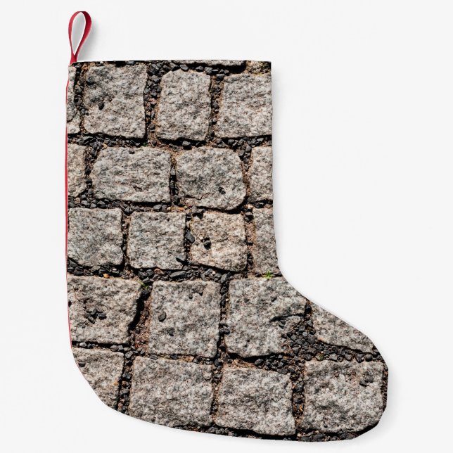 Old cobble stone pattern at the streetabstract,anc liten julstrumpa (Framsidan)