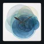 Omvandla planeter - Vattenfärgcirklar Fyrkantig Klocka<br><div class="desc">Att utveckla planeter jag av Grace Popp. Vattenfärgskretsar skapar planetliknande former som överlappar varandra för att avslöja vackra variationer av blått och teal.</div>