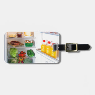 Öppna kylskåp fylld med mat bagagebricka