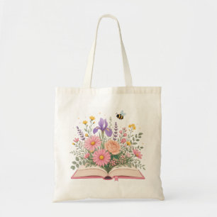 Öppnad bok med utbrutna vilda blommor och bi tygkasse