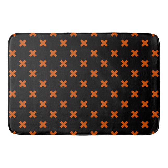 Orange kor sytlar på svart badrumsmatta (Framsidan)