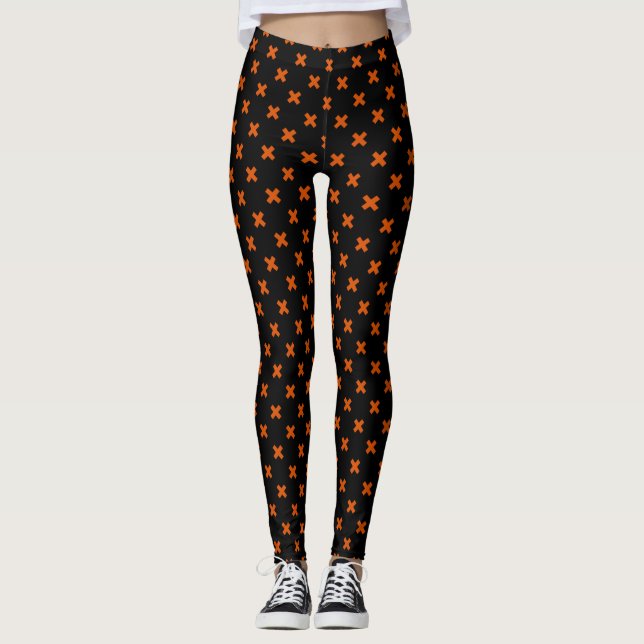 Orange kor sytlar på svart leggings (Framsida)