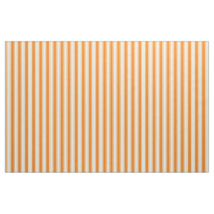 Orange- och krämtickning på rand tyg
