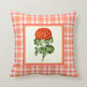 Orange pelargon för vintage med plädmönstergrä kudde