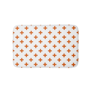 Orange polka kor på vitt badrumsmatta