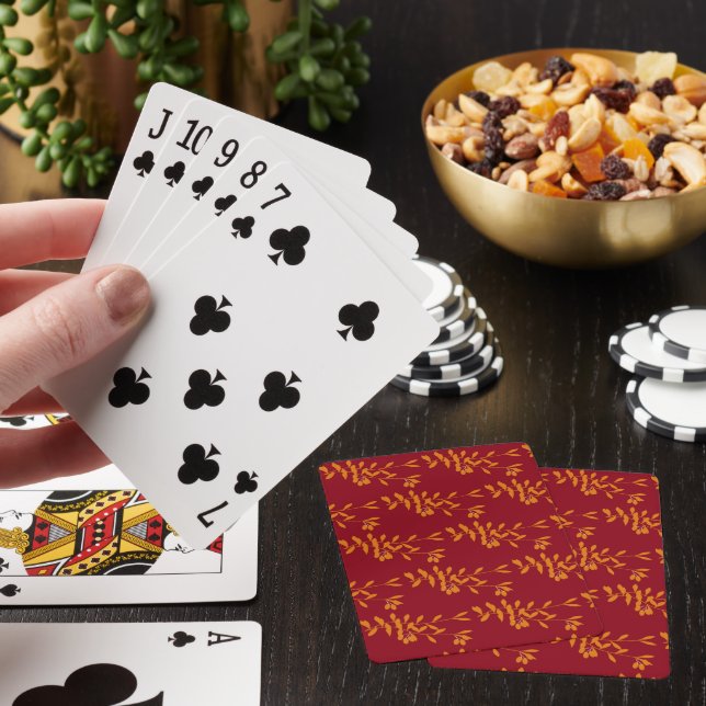 Orange silhouette gren löv på rött casinokort (På plats)