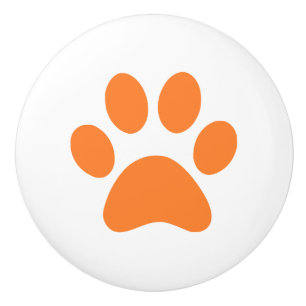 Orange tasstryckpawprint knopp