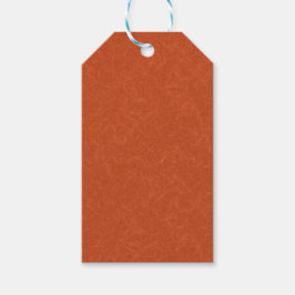 Orange textured surface with swirling pattern presentetikett