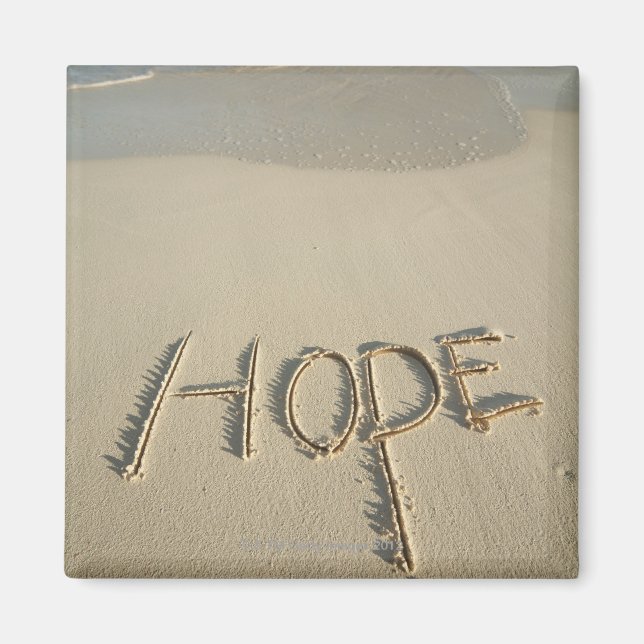 Ord "Hope"-sand som skrevs på stranden med Magnet (Framsidan)