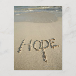 Ord "Hope"-sand som skrevs på stranden med Vykort