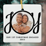 Our 1st Christmas Engaged Photo Keepsake Julgransprydnad Keramik<br><div class="desc">This keepsake First Christmas Engaged photo ornament is decorated with the word JOY in black,  stylish script typography. Easily customizable.</div>