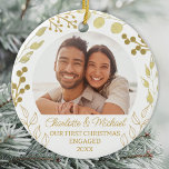 Our First Christmas Engaged Gold Foliage Photo Julgransprydnad Keramik<br><div class="desc">This elegant Engagement Christmas Ornament is decorated with gold foliage on a white background.
Easily customizable with your photo,  names,  and year.
Original Watercolor © Michele Davies.</div>