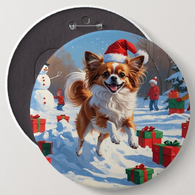 Papillon-hund springer i snö med julhatt knapp (Framsida & baksida)