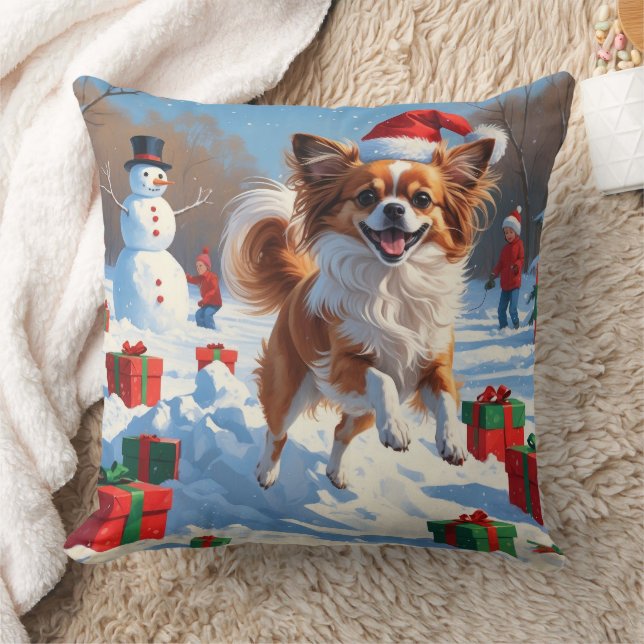 Papillon-hund springer i snö med julhatt kudde (Filt)