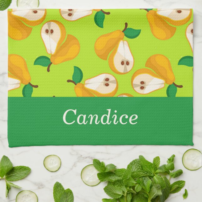 Päron för orange av eget namn på grönt kökshandduk (Vikta)