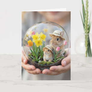 Påskharar i terrarium hållna av barns hand kort