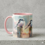 Pastel Watercolor Birds Fencepost Sunset Mugg<br><div class="desc">Soft watercolor brushwork captures two fluffy songbirds resting on weathered fence posts as a glowing sunset spreads across a dreamy countryside sky. Gentle washes of peach, blush pink, pale blue, and warm gold blend into a tranquil horizon, creating a calm pastoral atmosphere. The birds appear round and feathery, their delicate...</div>