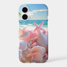 PASTELL ROSA SNECKOR PÅ EN SANDIG STRAND