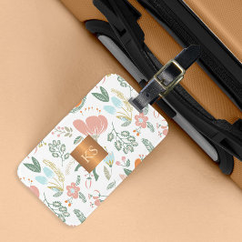 Pastellblommor med metalliskt kopparmonogram bagagebricka