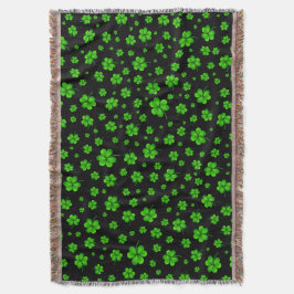 Pattern of green shamrocks on black background filt