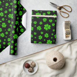 Pattern of green shamrocks on black background presentpapper