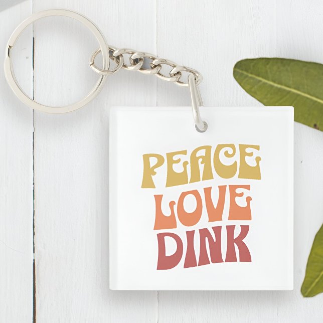 Peace Kärlek Dink Dubbla Sided Acrylic Keychain (Peace Love Dink Double Sided Acrylic Keychain Next to a Plant)
