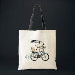 Peanuts | Snoopy & Woodstock Bicycle Tygkasse<br><div class="desc">Pedal into style and classic charm with this adorable cream canvas tote bag, featuring Snoopy and Woodstock on a bicycle! This fun tote showcases a delightful line-art illustration of Snoopy, wearing sunglasses, happily riding a vintage-style blue bicycle with Woodstock perched safely behind him. The dashed lines behind the back wheel...</div>