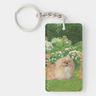 Pekingeser i en trädgård nyckelring