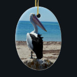 Pelican på Beach Sten, Julgransprydnad Keramik<br><div class="desc">Att stå på en strand sten vid havet är en hungrig,  stilig pelikan som väntar på smakfiskmoraler.</div>