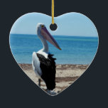 Pelican på Beach Sten, Julgransprydnad Keramik<br><div class="desc">Att stå på en strand sten vid havet är en hungrig,  stilig pelikan som väntar på smakfiskmoraler.</div>