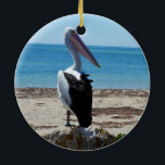Pelican på Beach Sten, Julgransprydnad Keramik<br><div class="desc">Att stå på en strand sten vid havet är en hungrig,  stilig pelikan som väntar på smakfiskmoraler.</div>