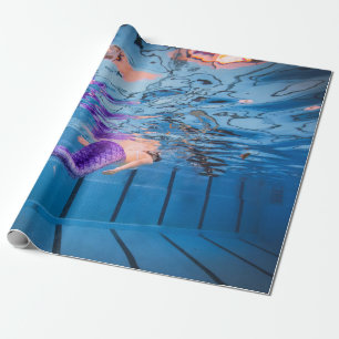Person i lila byxor ljugande på blå hammock presentpapper