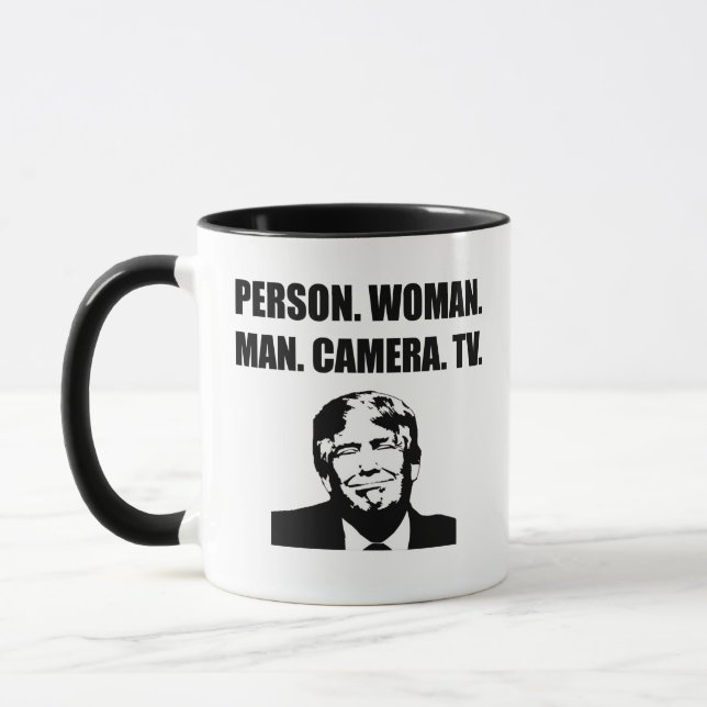 Person. Kvinna. Man. Kamera. TV.Trumpning Mugg (Vänster)