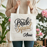 Personalized Gold Bride Squad Bachelorette Party Tygkasse<br><div class="desc">Get ready for the ultimate girls' getaway with this chic Bride Squad tote bag! Featuring elegant gold-toned typography and sparkling diamond accents, this bag is the perfect accessory for bachelorette weekends, bridal showers, or as a stylish wedding welcome bag. Durable and spacious, it's designed to hold all your party essentials...</div>