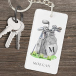 Personlig Golfer Monogram<br><div class="desc">Den här engramsnyckelkedjan i eleganten har en grått-golfpåse i snyggt fylld med klubbar, omgiven av en aning gräs i grönt. Konstruktionen innehåller ett enkelt inledande mongram av serif-typsnitt på påsen, som sömlöst blandas in i den övergripande utformningen. Under monogrammet visas namn i ett matchande serif-teckensnitt och en sofistikerad tryckning läggs...</div>