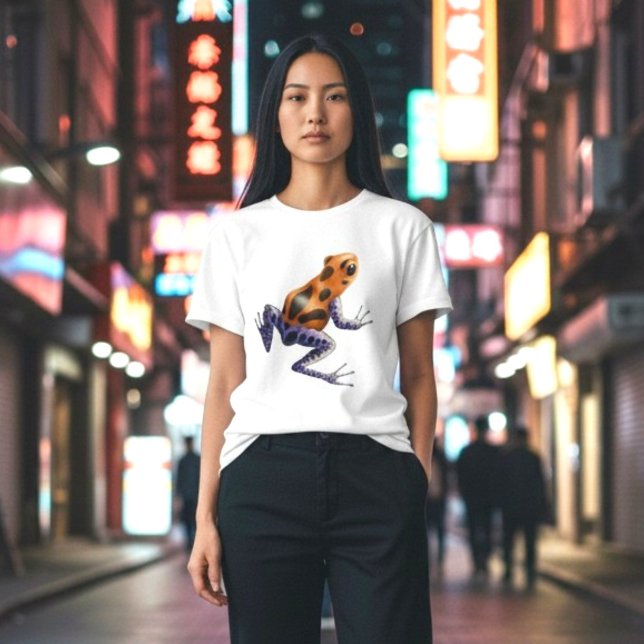 Pilgiftsgroda Tee Shirt (A vibrant orange and blue poison dart frog on a classic white tee, on a woman in the city at night.)