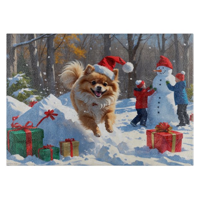 Pomeranian springer i snö med julhatt (Framsidan)